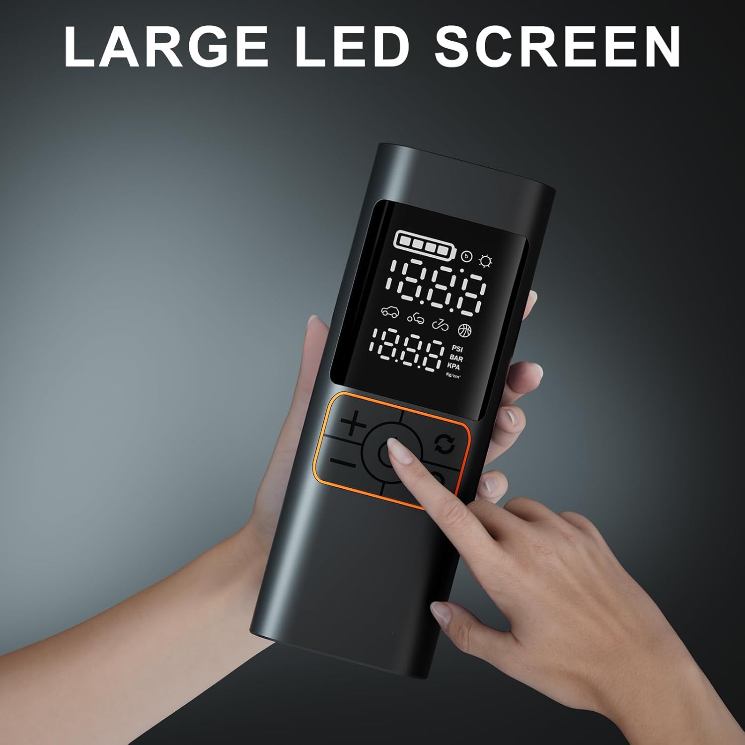 Hand holding a black electronic device with a large LED screen on a gray background