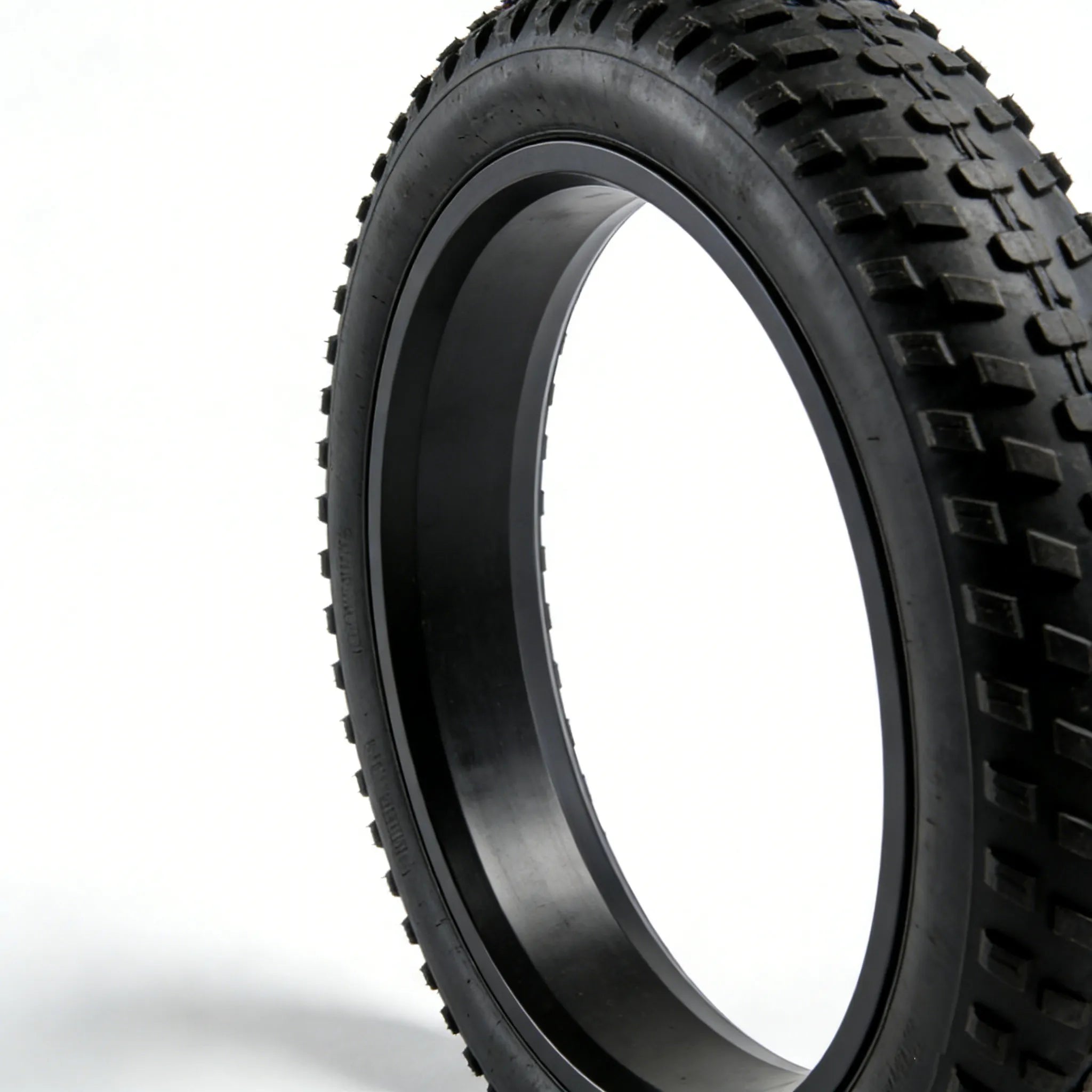 Close-up of 20×4.0 fat tire tread pattern and sidewall, black off-road e-bike tire showing rubber texture and lug design