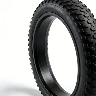 Close-up of 20×4.0 fat tire tread pattern and sidewall, black off-road e-bike tire showing rubber texture and lug design