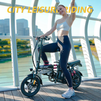 Woman standing next to a DDC Sport electric bike with a cityscape background